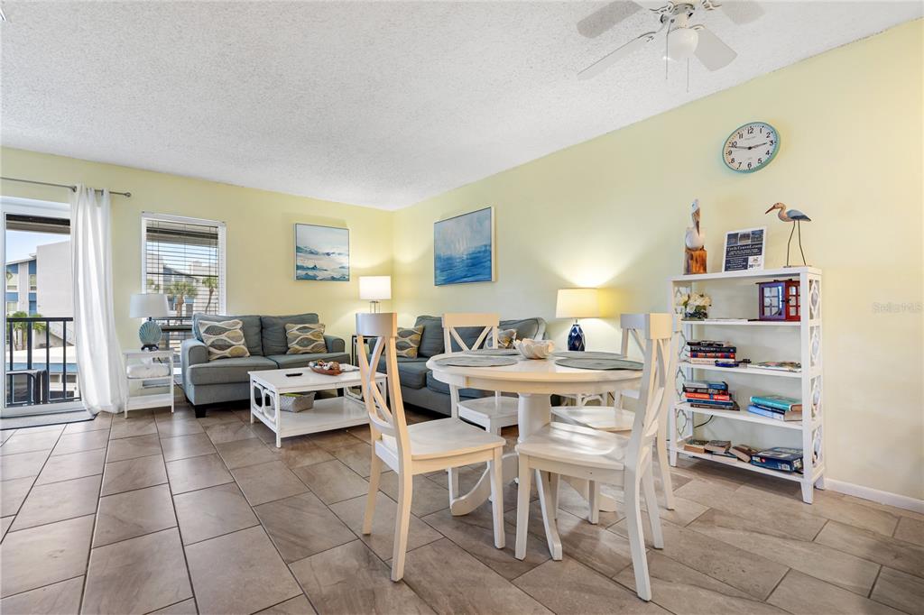 230 Medallion Boulevard, Unit E Madeira Beach, FL 33708 - Photo 6 of 35 a living room with furniture and a table