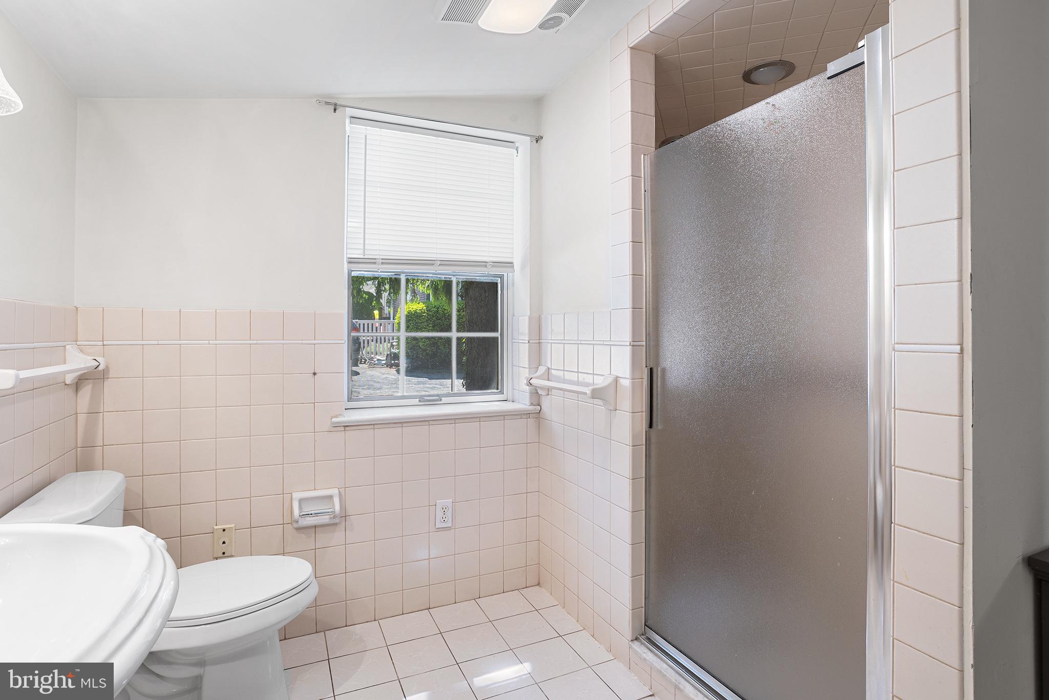 217 East Thomson Avenue Springfield, PA 19064 - Photo 13 of 32 a bathroom with a toilet and a shower