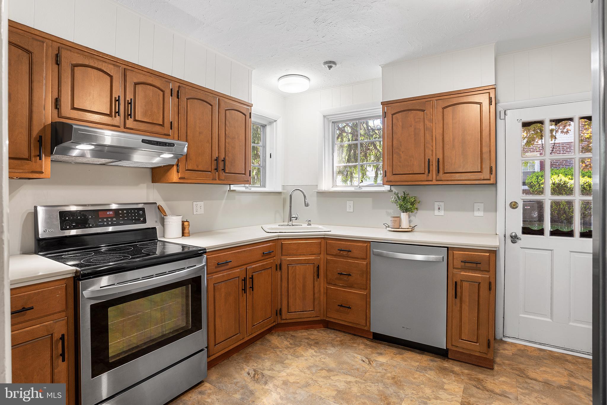 217 East Thomson Avenue Springfield, PA 19064 - Photo 14 of 32 a kitchen with stainless steel appliances granite countertop a stove sink and cabinets