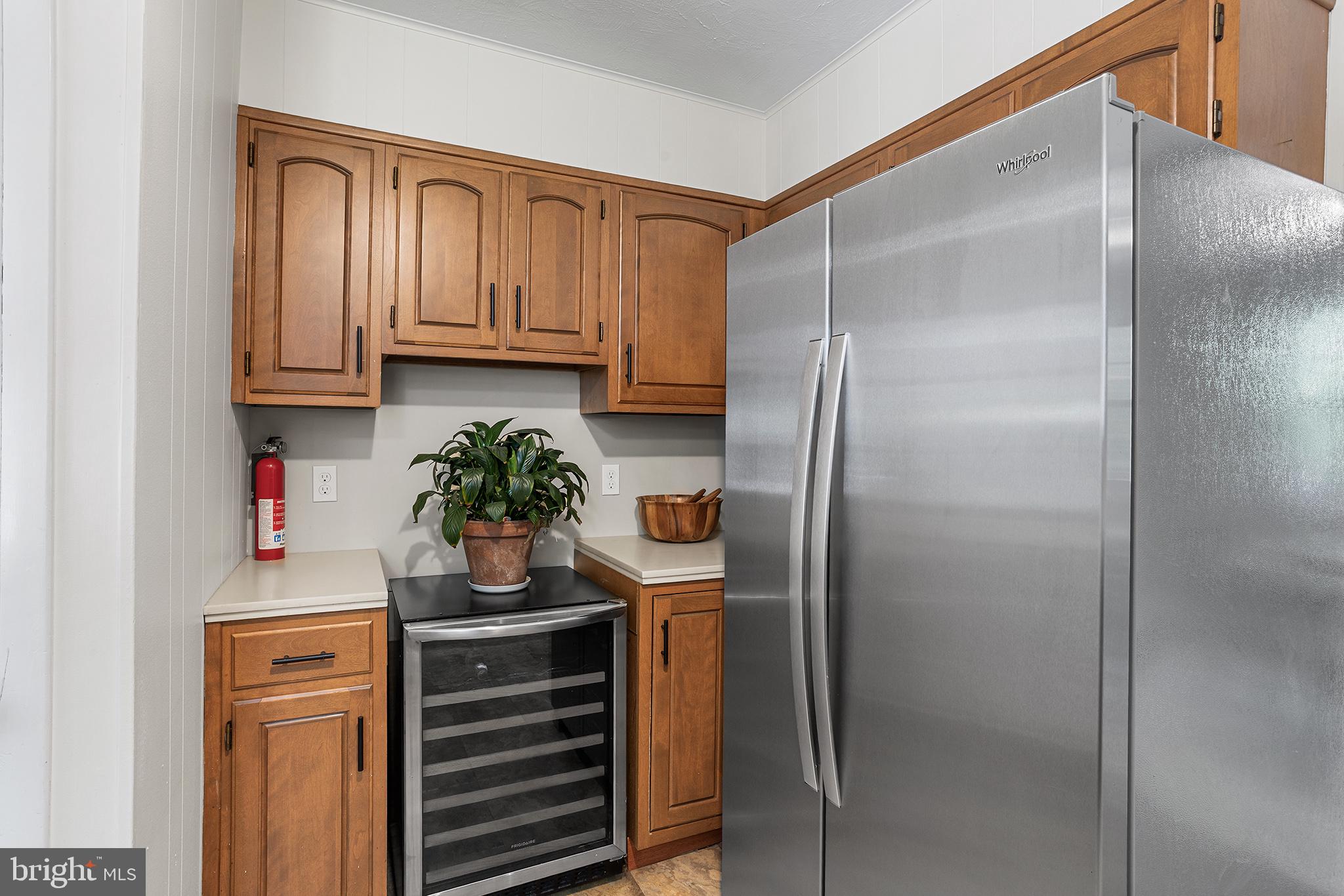 217 East Thomson Avenue Springfield, PA 19064 - Photo 17 of 32 a kitchen with a refrigerator and a potted plant