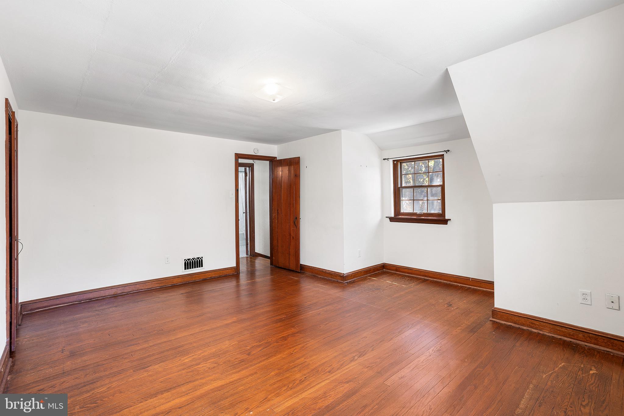 217 East Thomson Avenue Springfield, PA 19064 - Photo 20 of 32 an empty room with wooden floor and windows