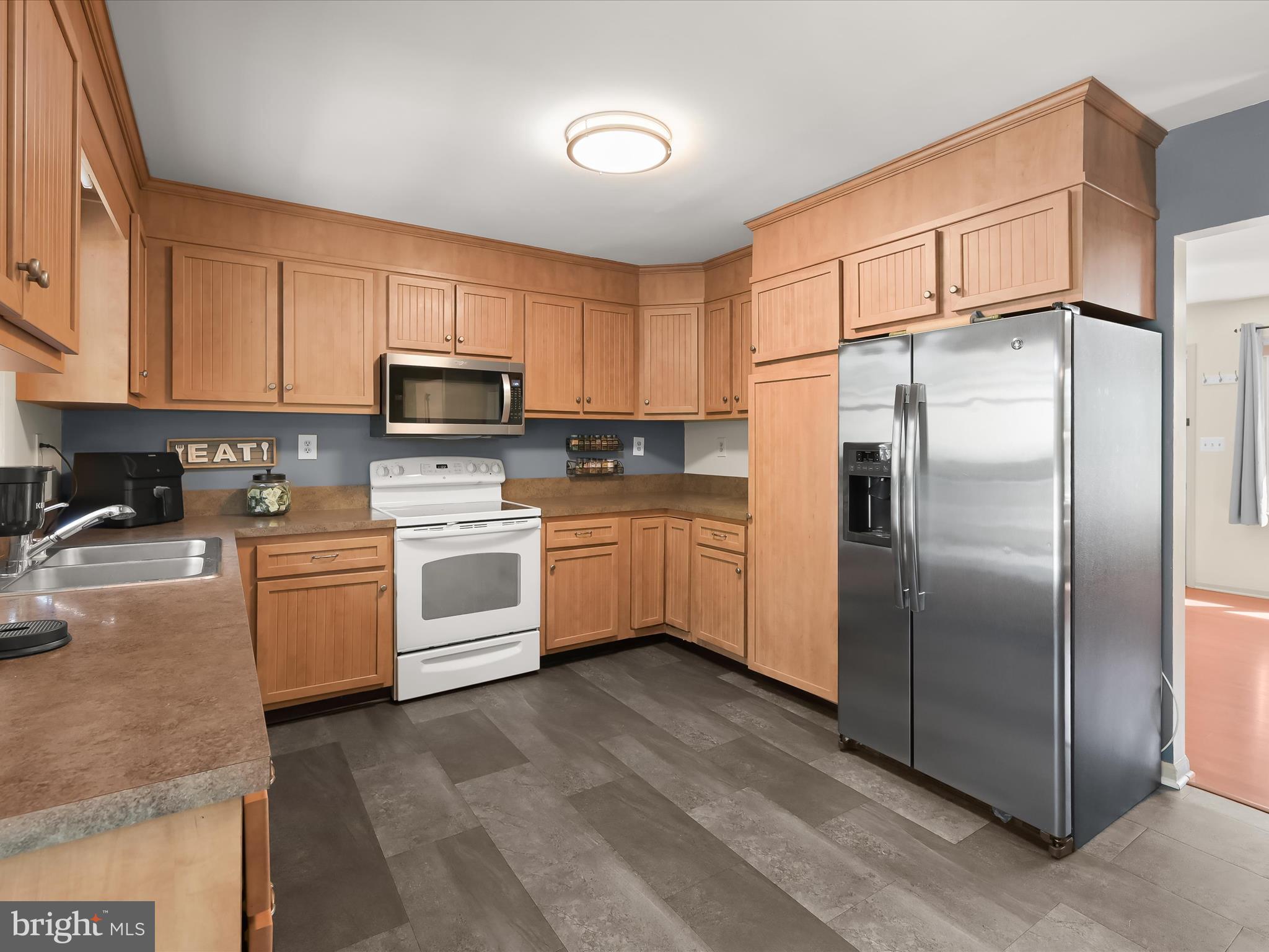 4950 Fleming Road Mount Airy, MD 21771 - Photo 17 of 64 a kitchen with white cabinets stainless steel appliances and a sink
