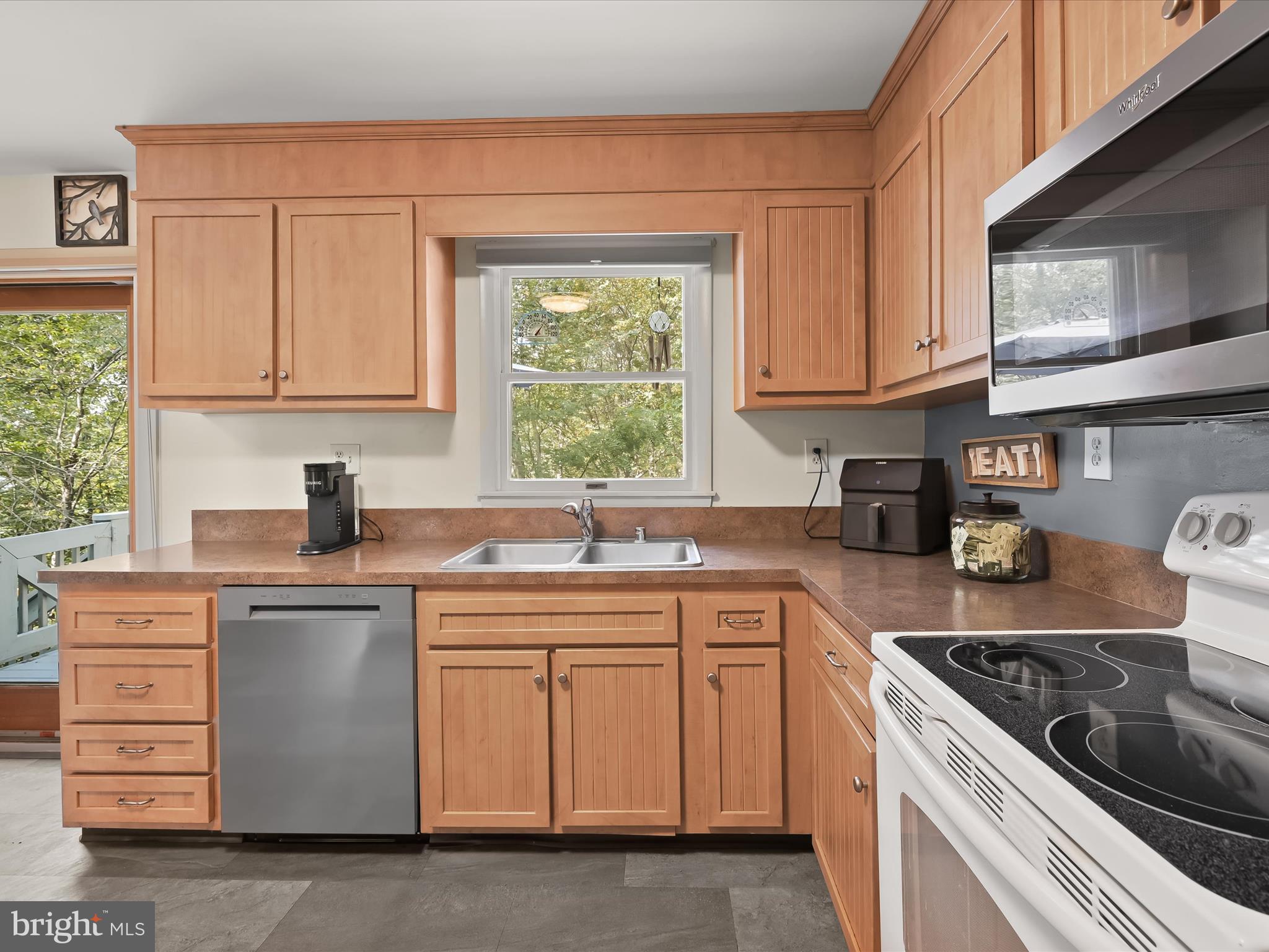 4950 Fleming Road Mount Airy, MD 21771 - Photo 19 of 64 a kitchen with cabinets appliances a sink and a window