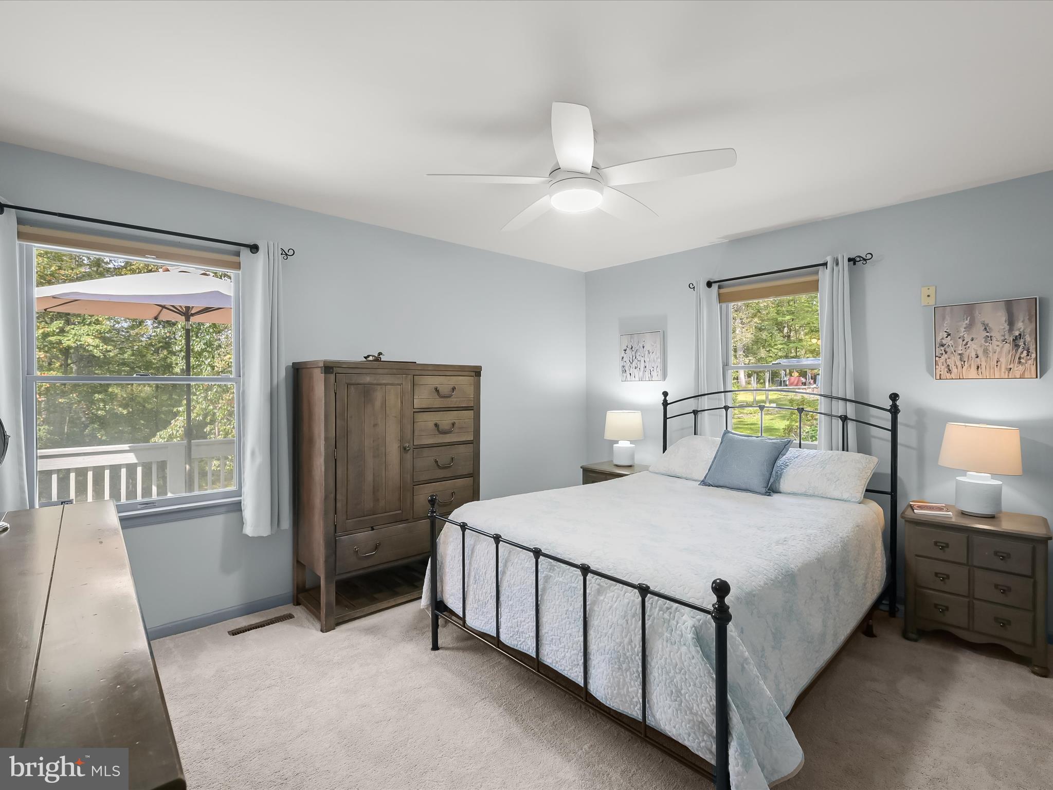 4950 Fleming Road Mount Airy, MD 21771 - Photo 7 of 64 a bedroom with a bed a chandelier and a large window