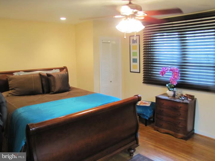 8503 Lynnewood Road Philadelphia, PA 19150 - Photo 15 of 20 a bedroom with a bed and a chandelier
