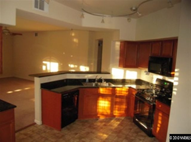 9050 Double R, Unit 1312 Reno, NV 89521 - Photo 4 of 9 a kitchen with a sink and a stove top oven