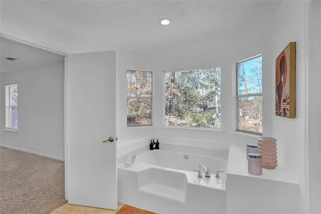 a bathroom with a bathtub and a window