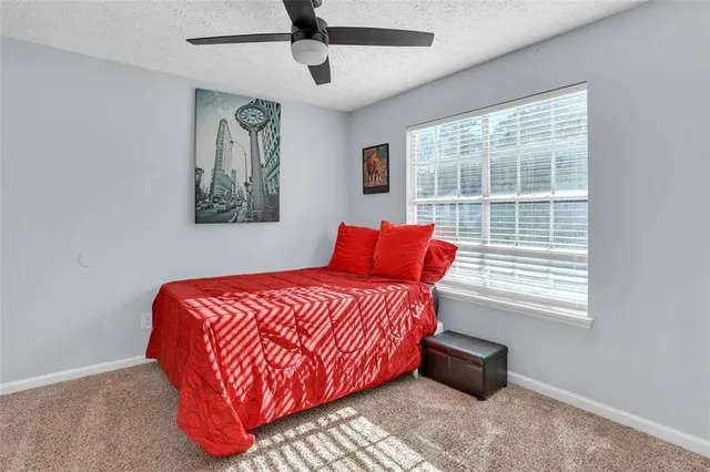 a blue bed sitting in a bedroom next to a window