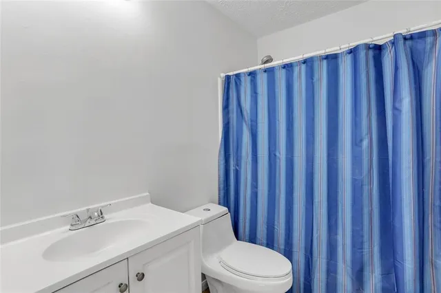 a bathroom with a sink a toilet and vanity