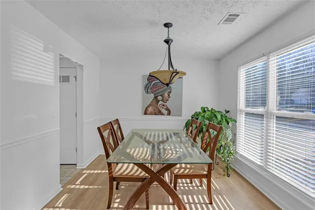 a view of a dining room with furniture window and wooden floor