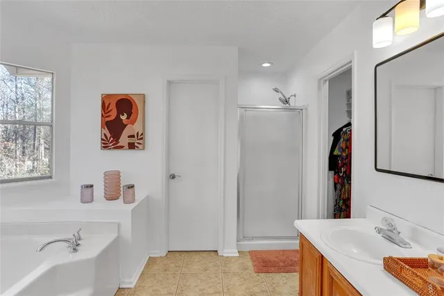 a bathroom with a tub sink and mirror