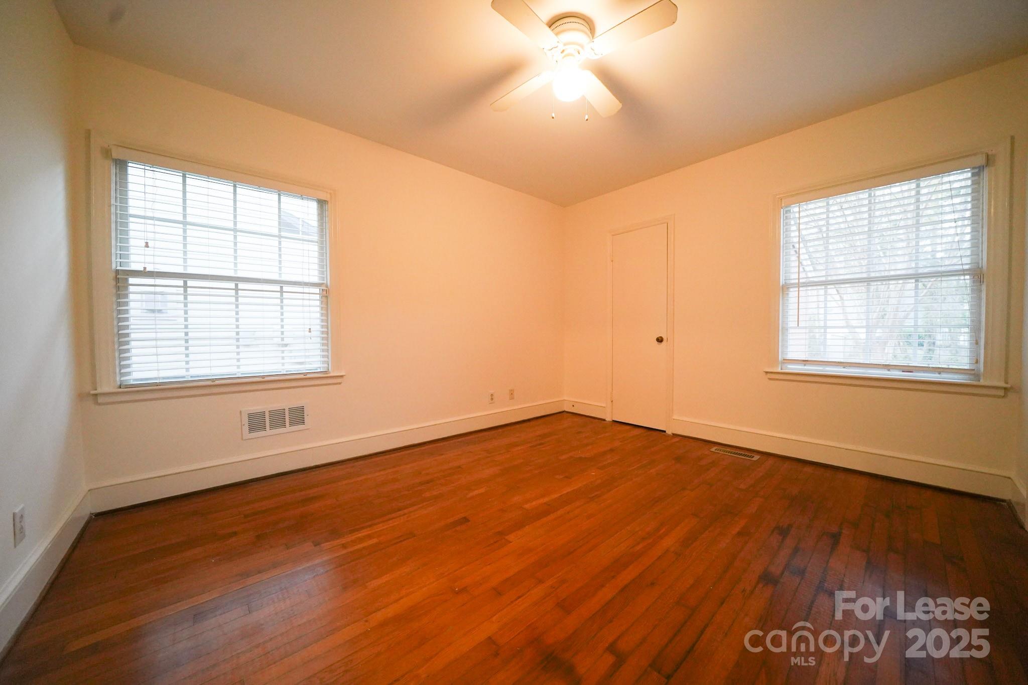 179 North Canterbury Road Charlotte, NC 28211 - Photo 12 of 15 an empty room with wooden floor and windows