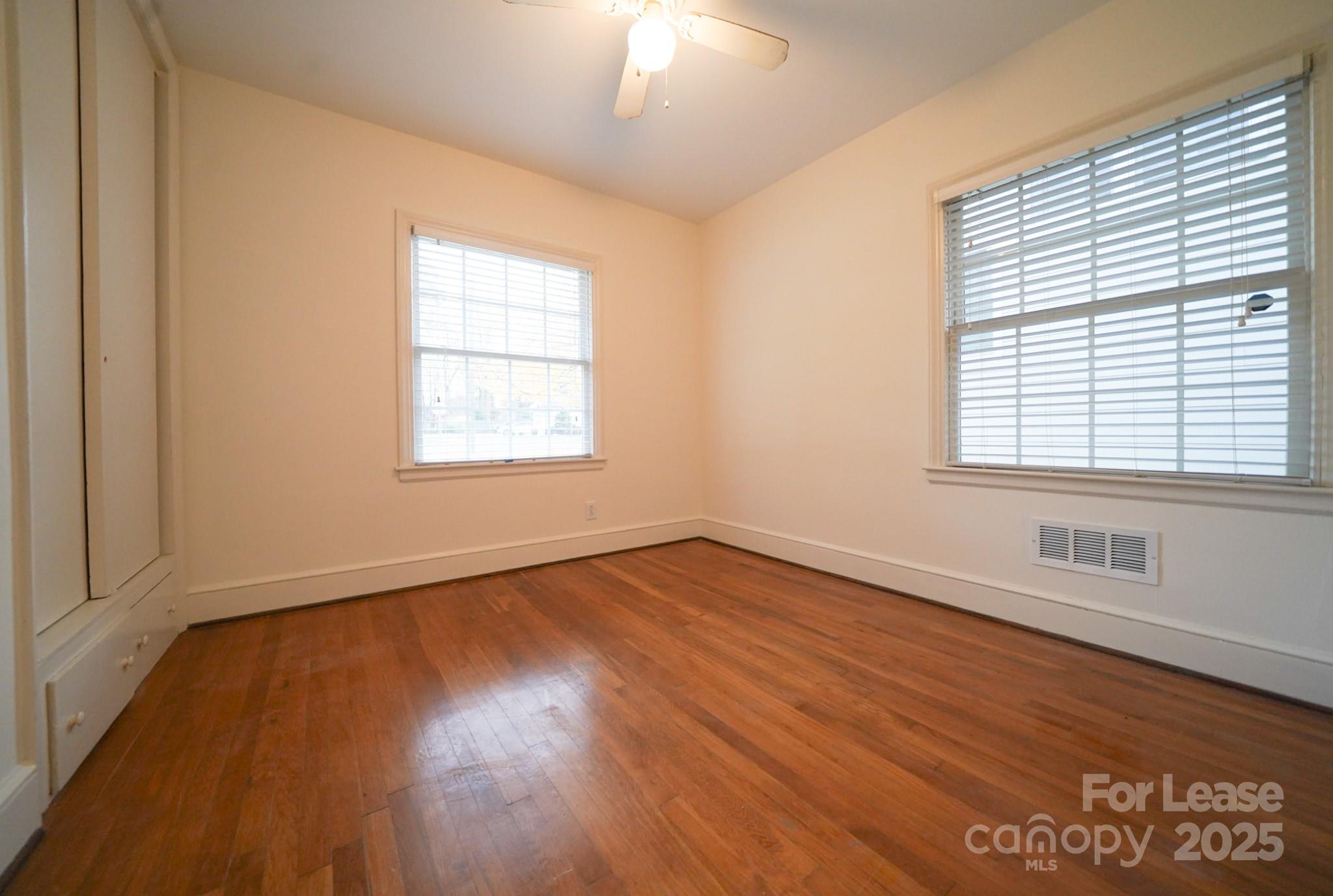 179 North Canterbury Road Charlotte, NC 28211 - Photo 15 of 15 an empty room with wooden floor and windows