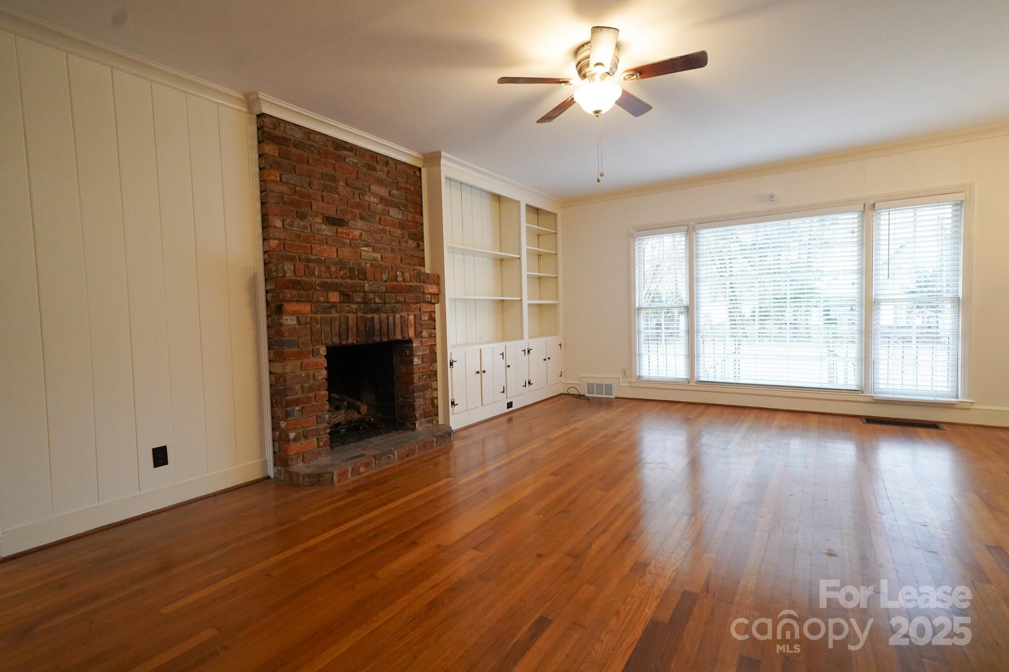 179 North Canterbury Road Charlotte, NC 28211 - Photo 4 of 15 a view of an empty room with wooden floor and a window
