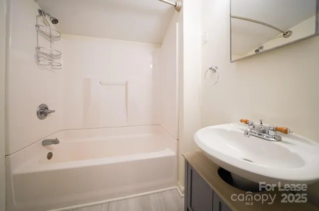 a bathroom with a bathtub and shower