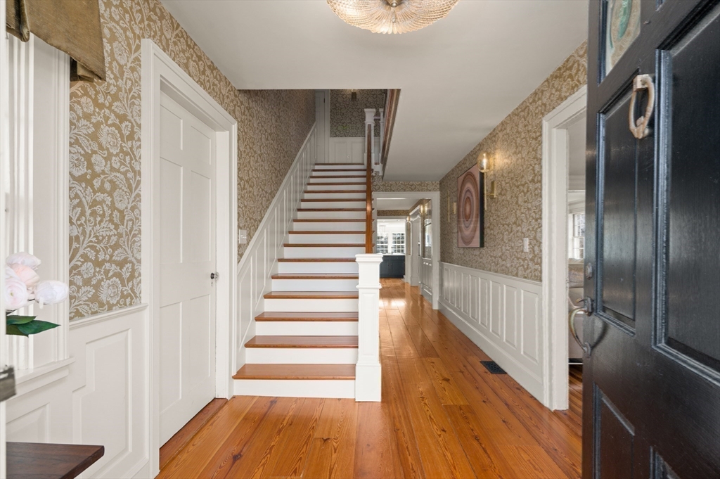 53 Salem Street Andover, MA 01810 - Photo 8 of 41 a view of a hallway with wooden floor and staircase