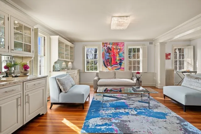 a living room with furniture and a dining table