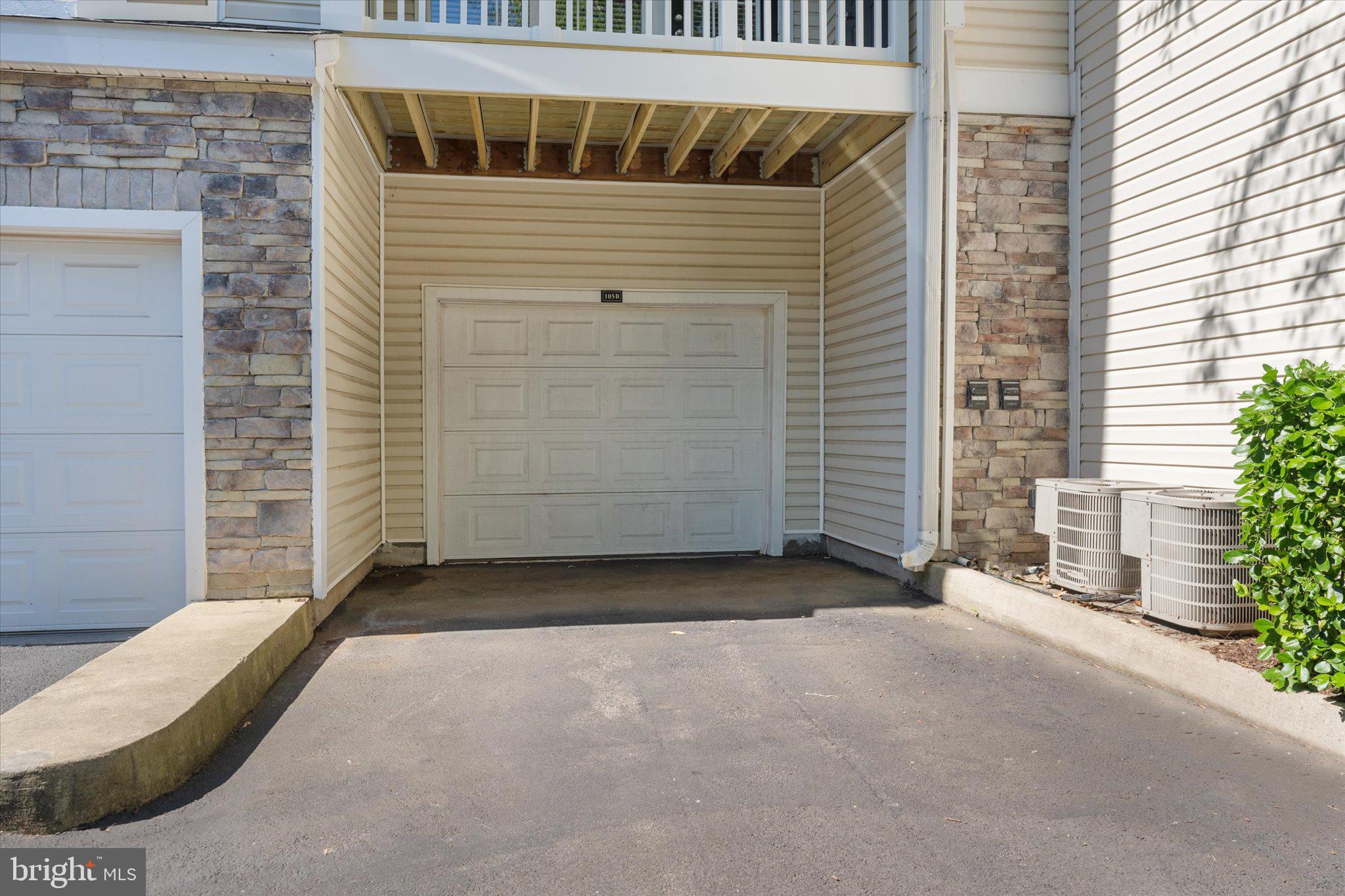 503 Sunset View Terrace Southeast, Unit 101 Leesburg, VA 20175 - Photo 31 of 39 Charming garage with stone accents.