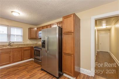 1714 Club Road, Unit 6 Charlotte, NC 28205 - Photo 4 of 14 a kitchen with granite countertop stainless steel appliances a refrigerator and cabinets
