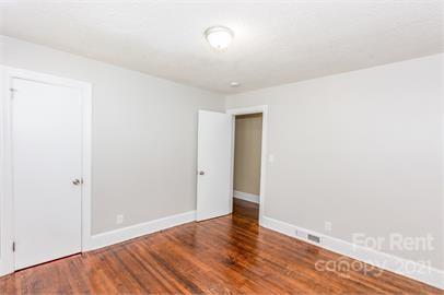 1714 Club Road, Unit 6 Charlotte, NC 28205 - Photo 8 of 14 a view of an empty room with wooden floor