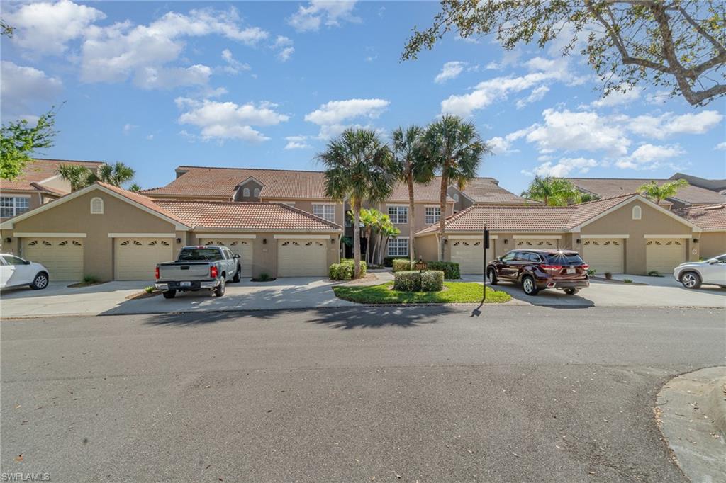 20151 Seagrove Street, Unit 207 Estero, FL 33928 - Photo 16 of 22 a view of a house with small space and a car park in front of it