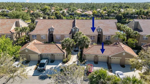 an aerial view of a house with swimming pool and lake view