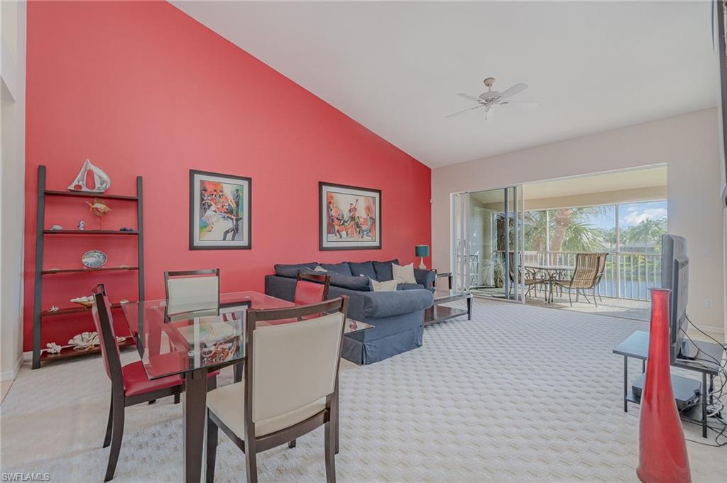 20151 Seagrove Street, Unit 207 Estero, FL 33928 - Photo 4 of 22 a living room with furniture and a floor to ceiling window