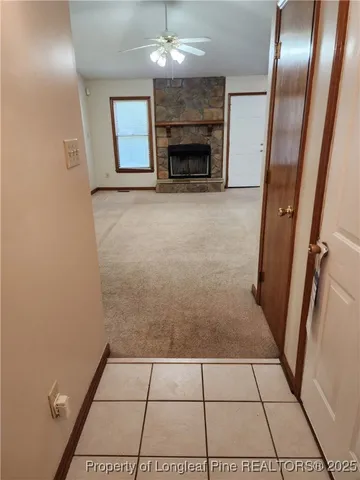 a view of an empty room with a fireplace