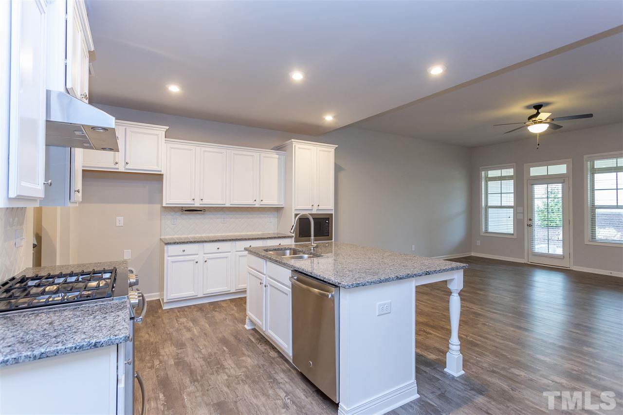 a kitchen with a stove a sink and a refrigerator