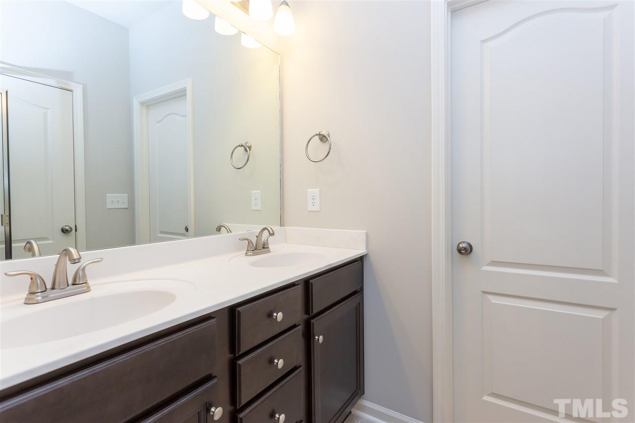 400 Piazza Way Wake Forest, NC 27587 - Photo 12 of 25 a bathroom with a sink and a mirror