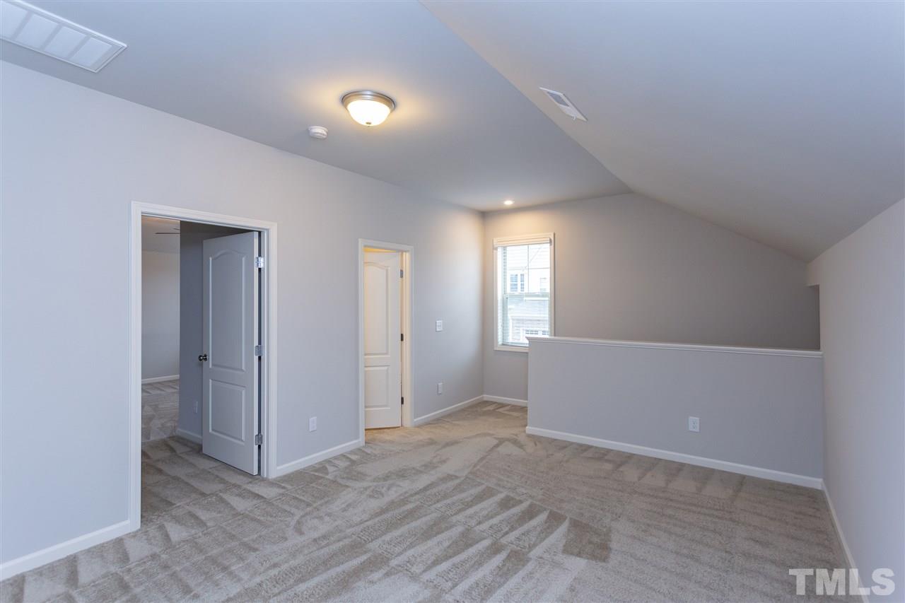 400 Piazza Way Wake Forest, NC 27587 - Photo 15 of 25 a view of an empty room with window and wooden floor