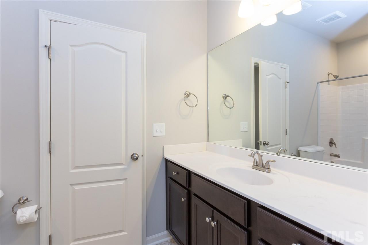 400 Piazza Way Wake Forest, NC 27587 - Photo 20 of 25 a bathroom with a sink double vanity and a mirror
