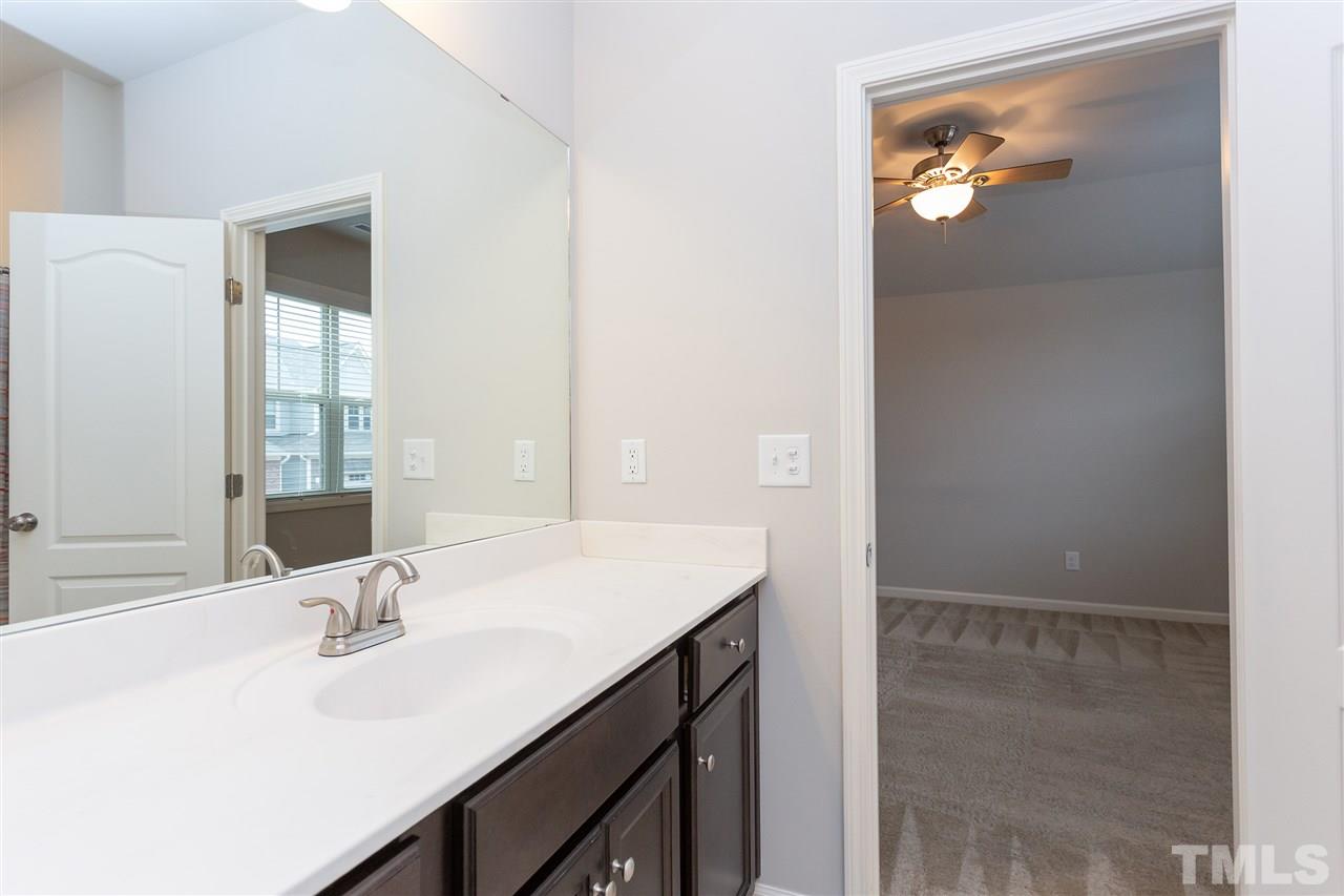 400 Piazza Way Wake Forest, NC 27587 - Photo 21 of 25 a bathroom with a sink and a mirror