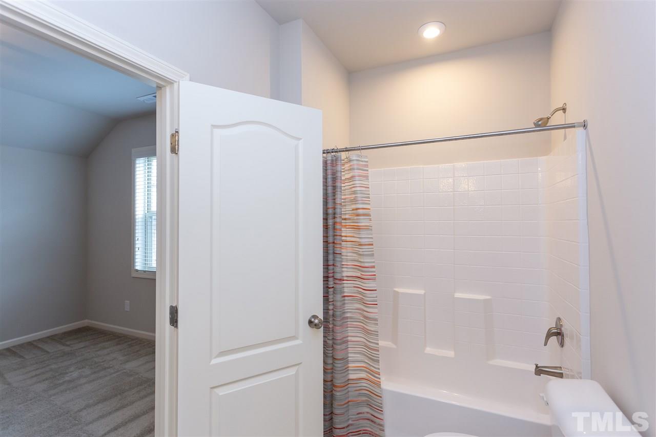 400 Piazza Way Wake Forest, NC 27587 - Photo 22 of 25 a bathroom with a bathtub and a shower