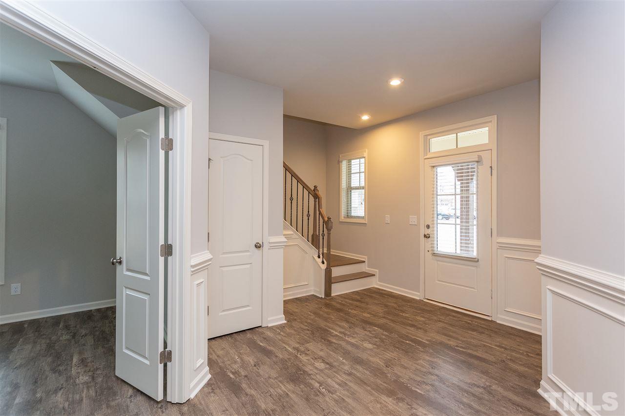 400 Piazza Way Wake Forest, NC 27587 - Photo 7 of 25 an empty room with wooden floor and windows