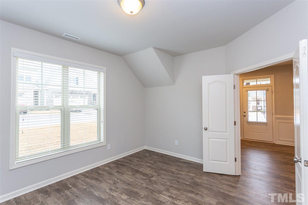 400 Piazza Way Wake Forest, NC 27587 - Photo 8 of 25 a view of an empty room with wooden floor and a window