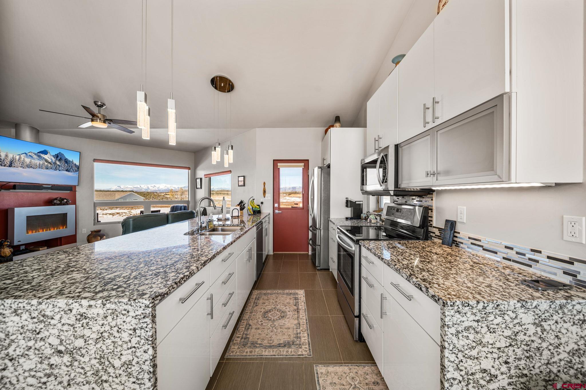 59 Chesterfield Place Ignacio, CO 81137 - Photo 11 of 35 a large kitchen with granite countertop a sink and cabinets