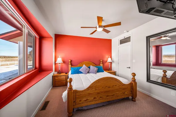 a bedroom with a bed and window