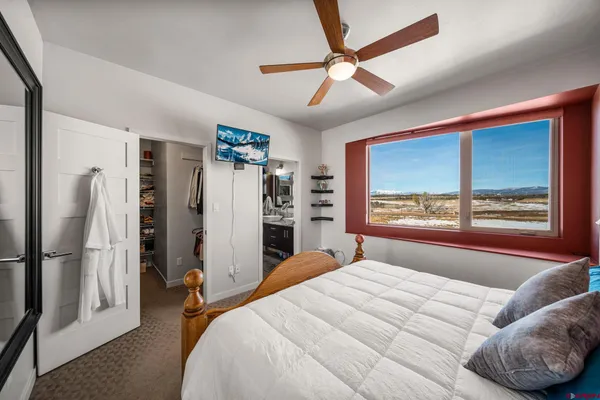 a bedroom with a large bed and a large window