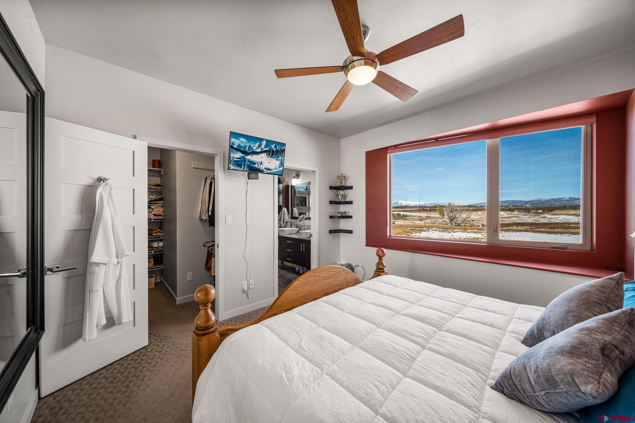 59 Chesterfield Place Ignacio, CO 81137 - Photo 19 of 35 a bedroom with a large bed and a large window