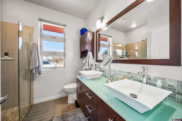 a bathroom with a sink vanity granite and a toilet