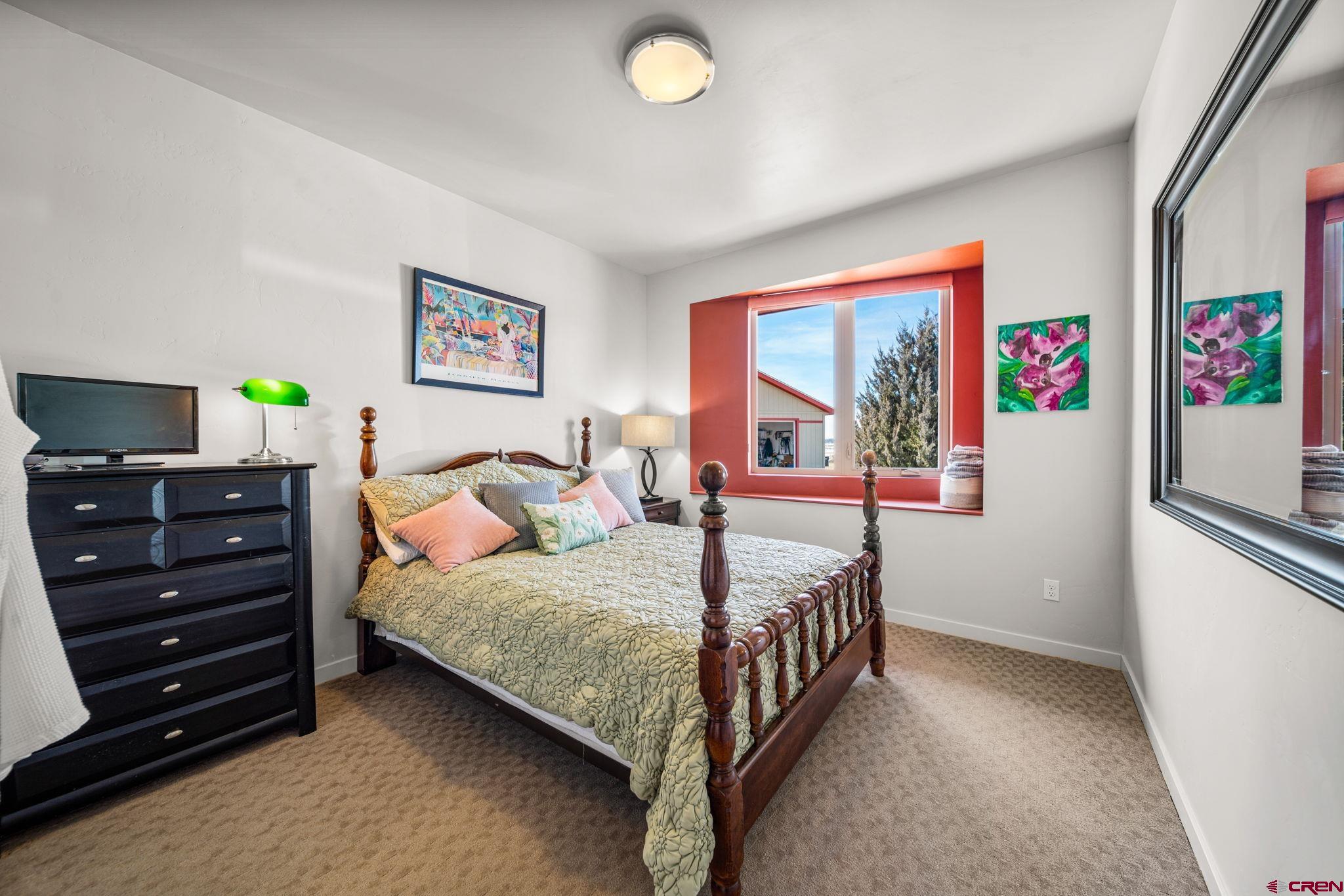 59 Chesterfield Place Ignacio, CO 81137 - Photo 21 of 35 a bedroom with a bed and a window