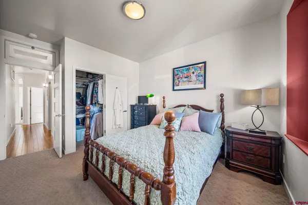 a bedroom with a bed and cabinets