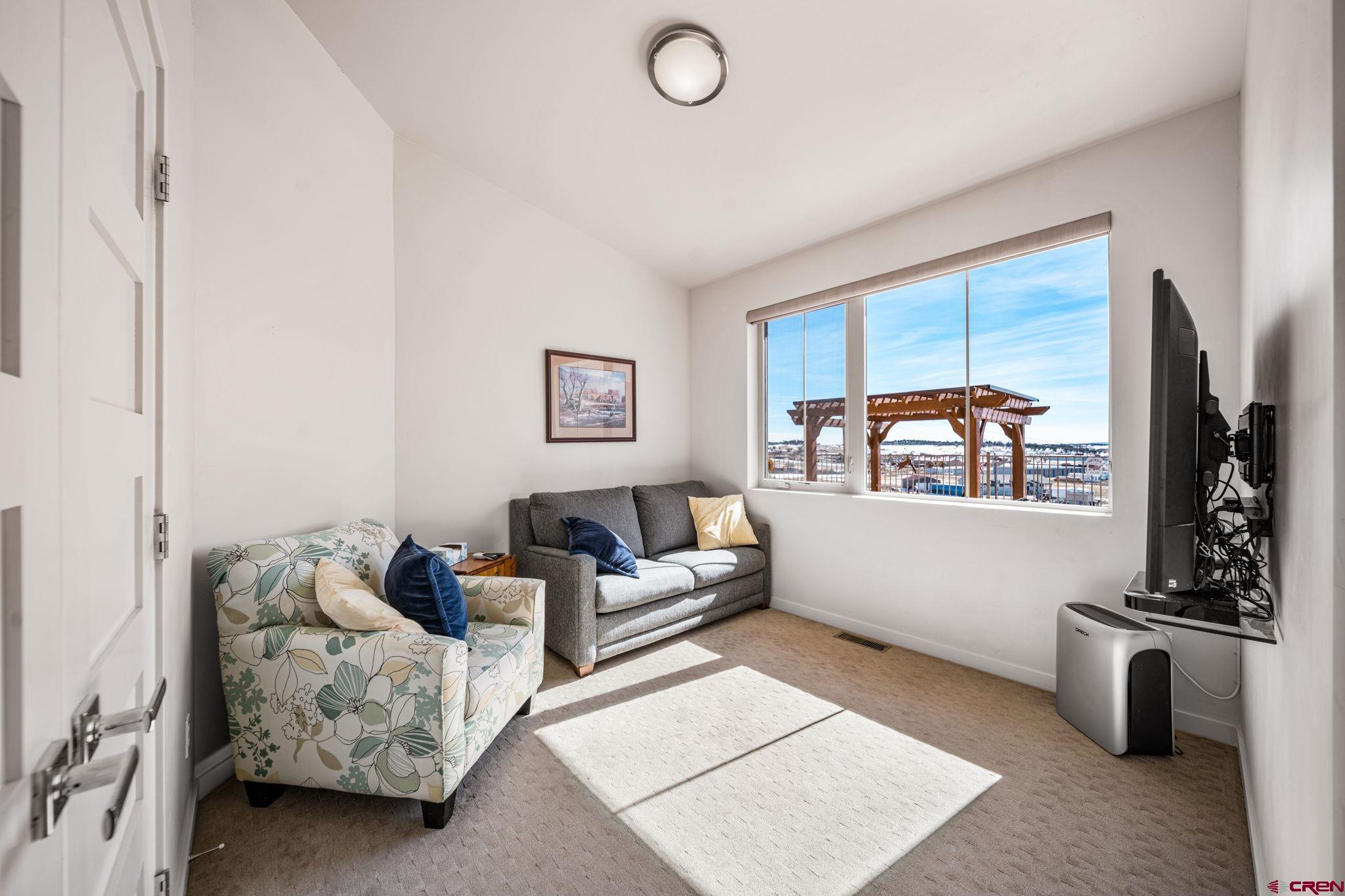 59 Chesterfield Place Ignacio, CO 81137 - Photo 23 of 35 a living room with furniture and a flat screen tv