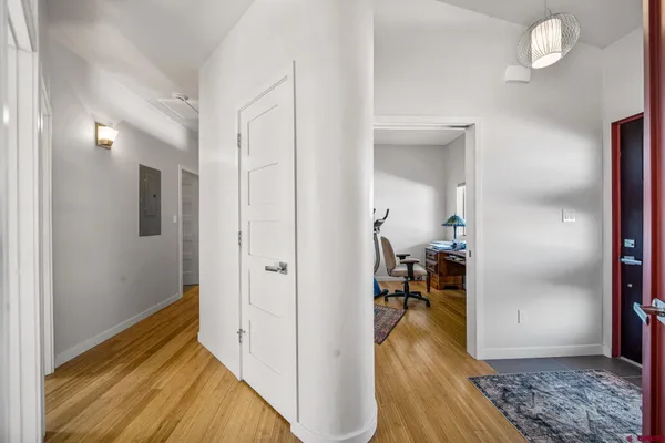 a view of a hallway view with wooden floor and furniture
