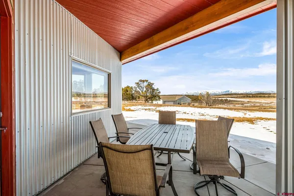 a view of a terrace with chair and dining table