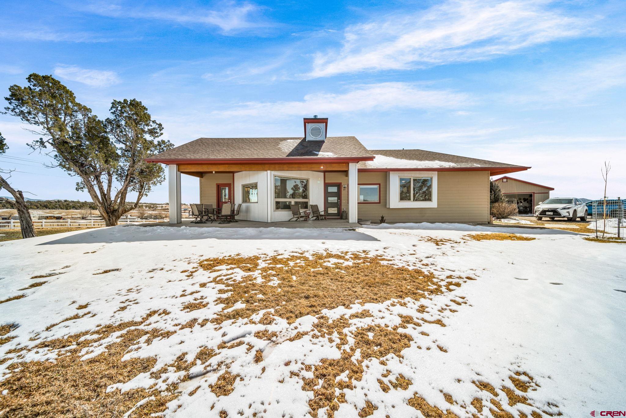 59 Chesterfield Place Ignacio, CO 81137 - Photo 3 of 35 a front view of a house with a yard