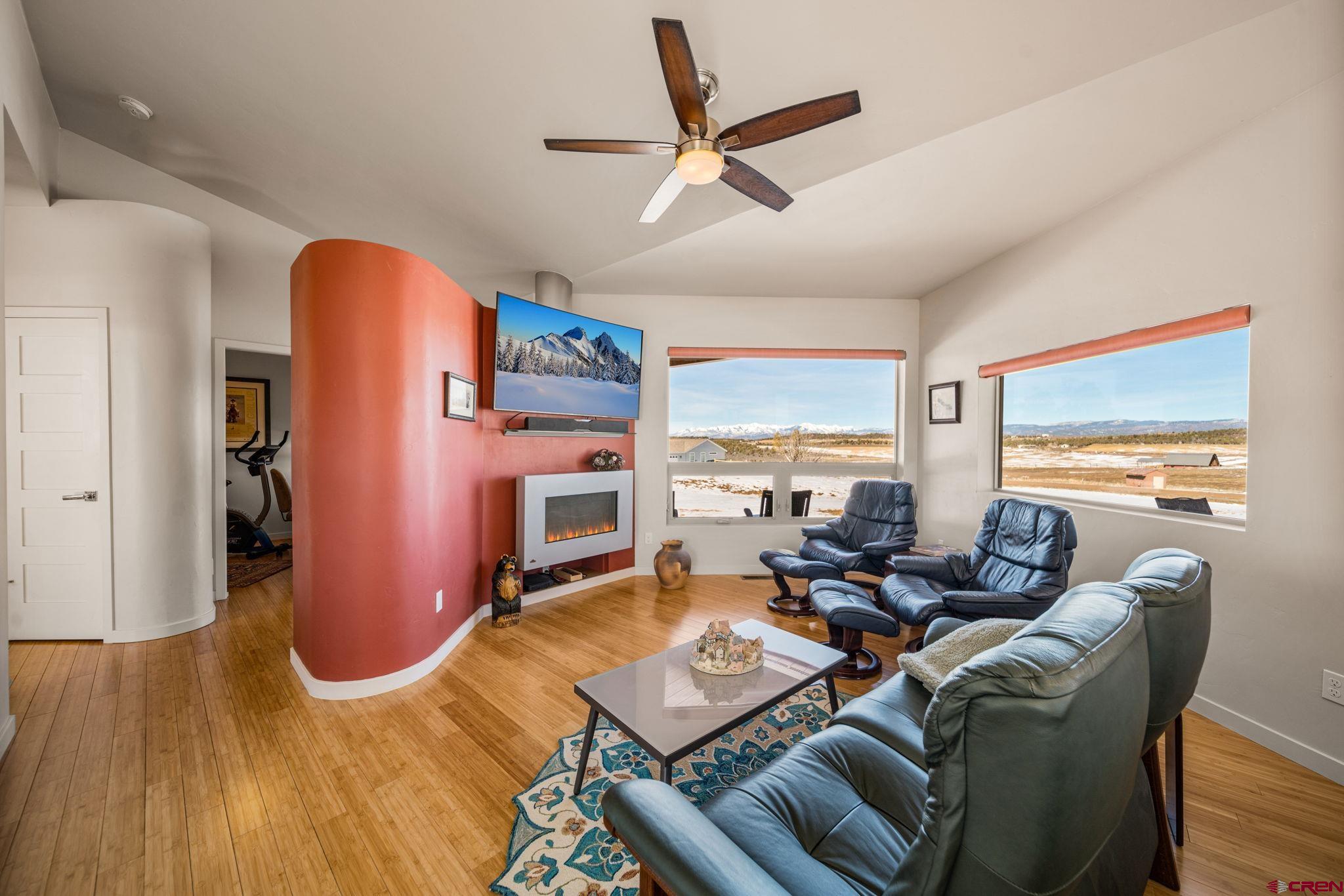 59 Chesterfield Place Ignacio, CO 81137 - Photo 8 of 35 a living room with furniture gym equipment and a large window
