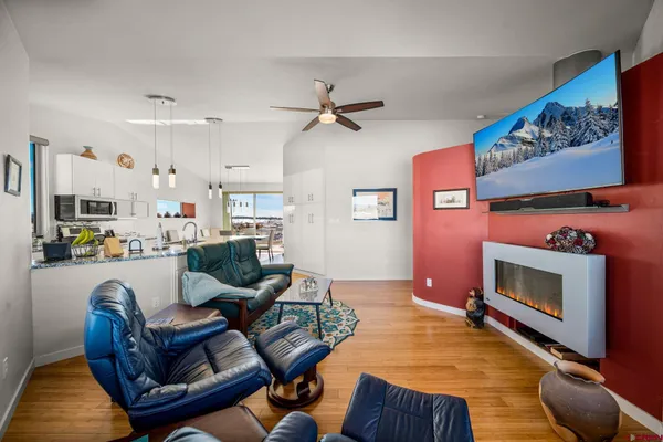 a living room with furniture a flat screen tv and a fireplace