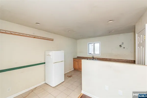 a room with a refrigerator and a stove
